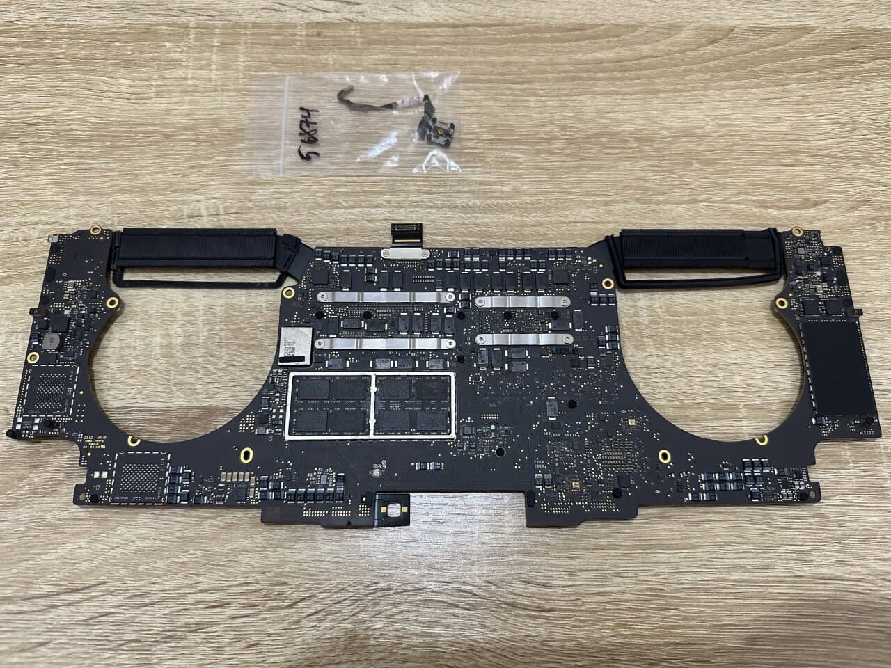MacBook motherboard removed during diagnosis of a laptop that was plugged in but not charging.